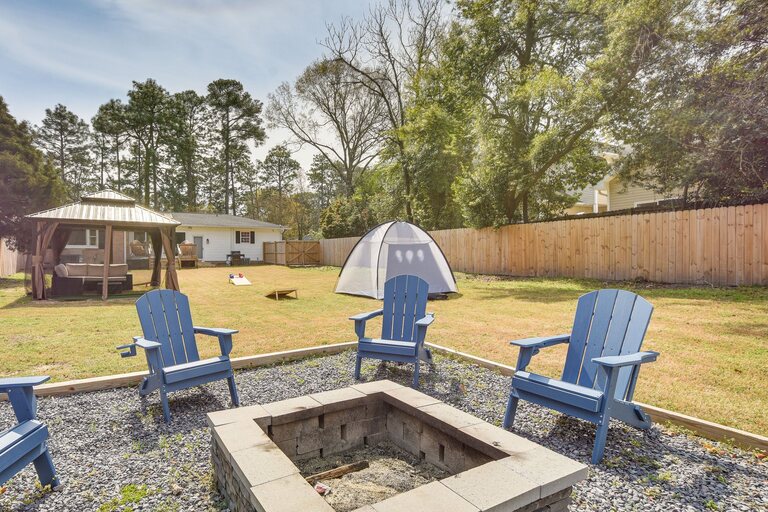 Fenced backyard and fire pit at Stay and Play on May